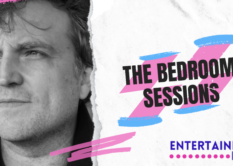 A graphic for The Bedroom Sessions showing the text in black over a pink and blue swoosh. There is a black and white image of James Walsh, he is looking off to the side and has dark hair falling over his forehead