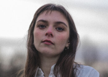 Jodie Nicholson is looking in to the camera she has shoulder length brown hair