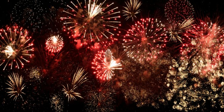 Red and gold fireworks bursting across the night sky to celebrate Bonfire Night