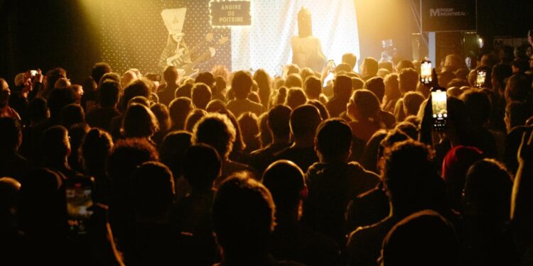 A crowd of people at a large music concert